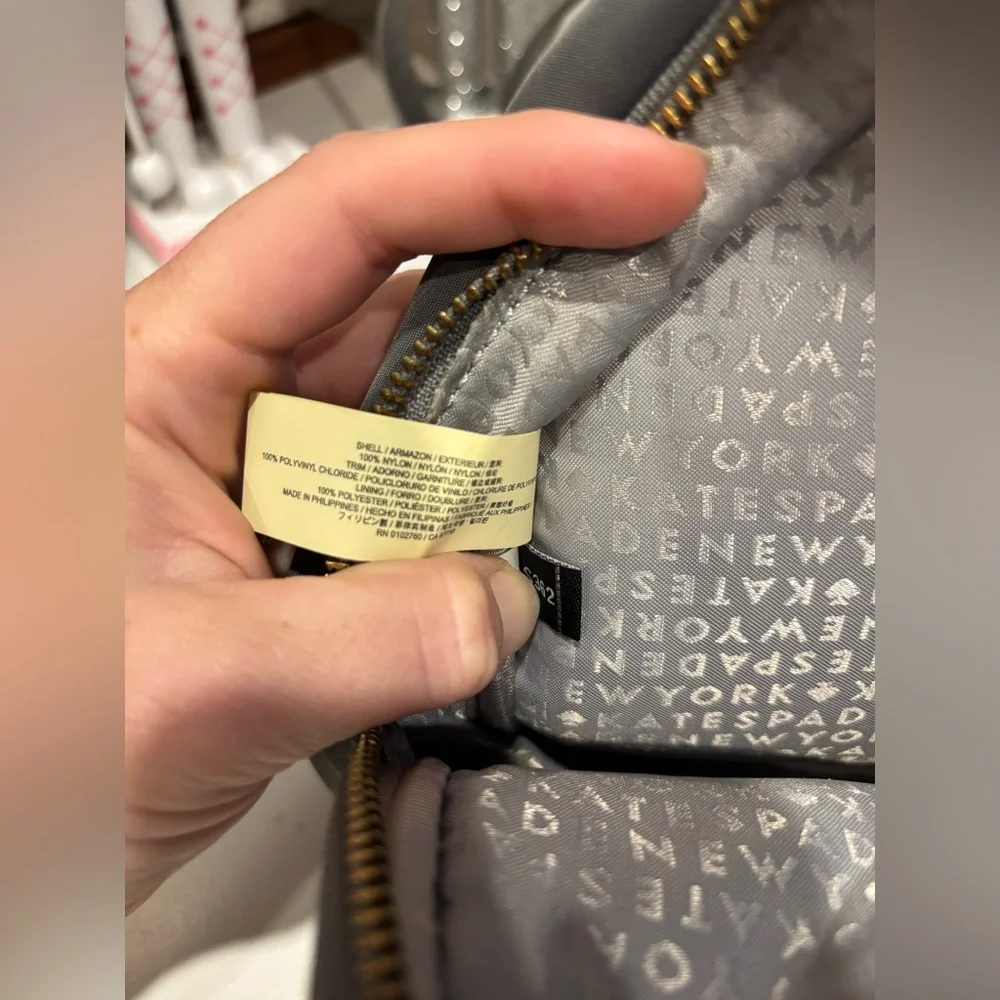 Kate Spade New York Mini Bradley nylon backpack in gray with gold zippers